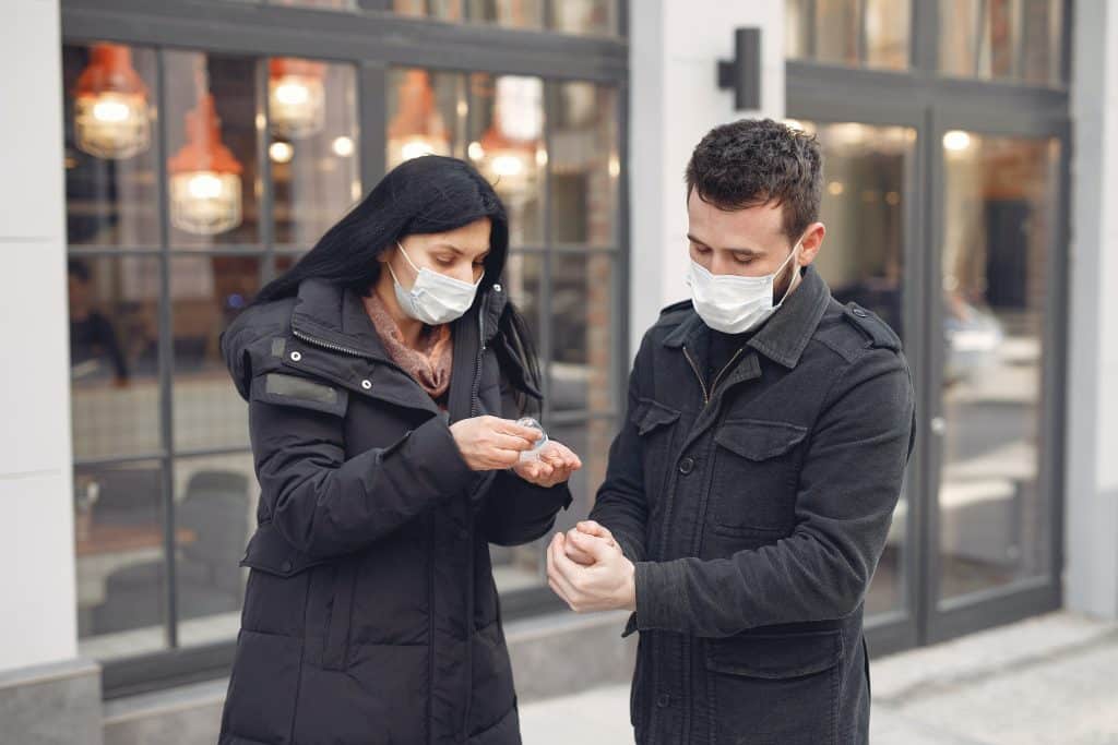 Deux personnes qui se lavent les mains avec du gel hydroalcoolique